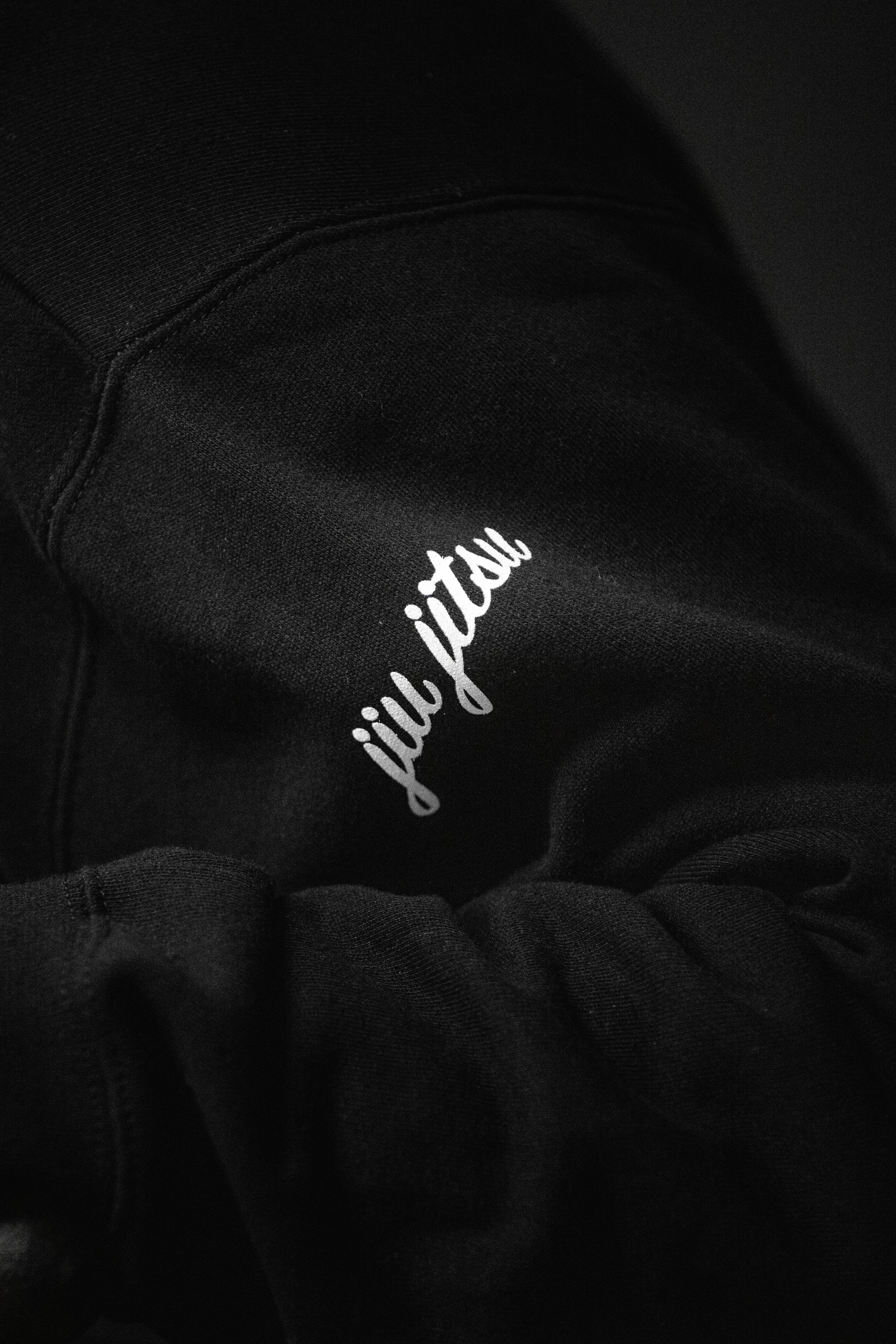 Cursive jiu jitsu sleeve print detail on SBR Choking Out Cancer Hoodie