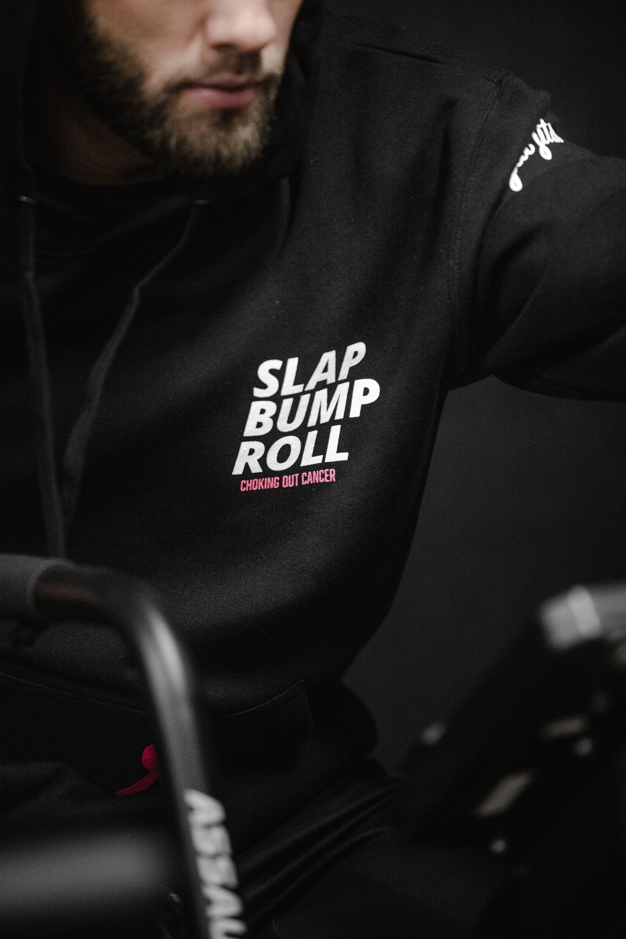 Athlete wearing SBR Choking Out Cancer Hoodie during training, SLAP BUMP ROLL chest print