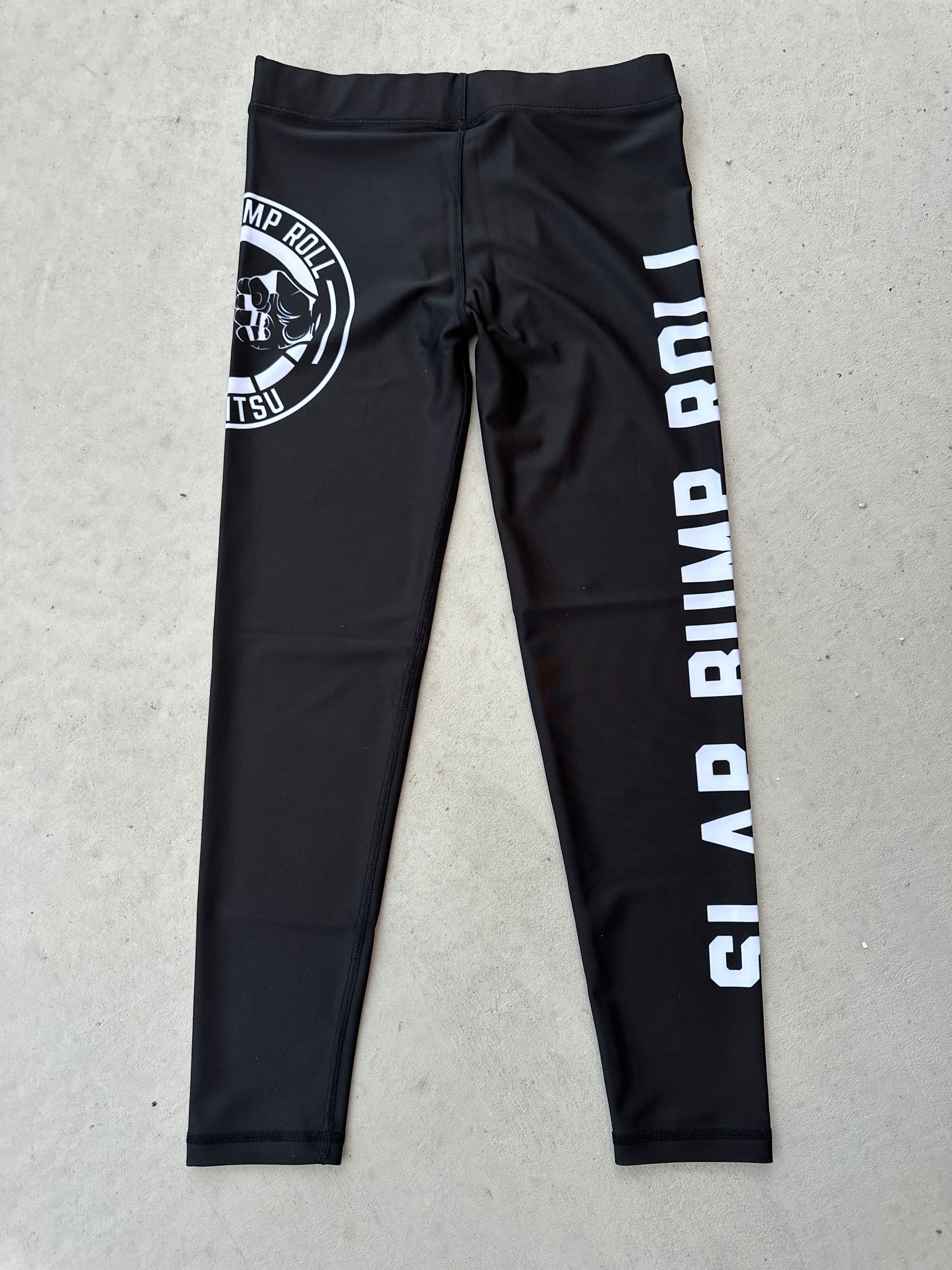 SBR Jiu Jitsu Spats in black with white SLAP BUMP ROLL leg print and fist bump circle logo, no-gi grappling compression tights