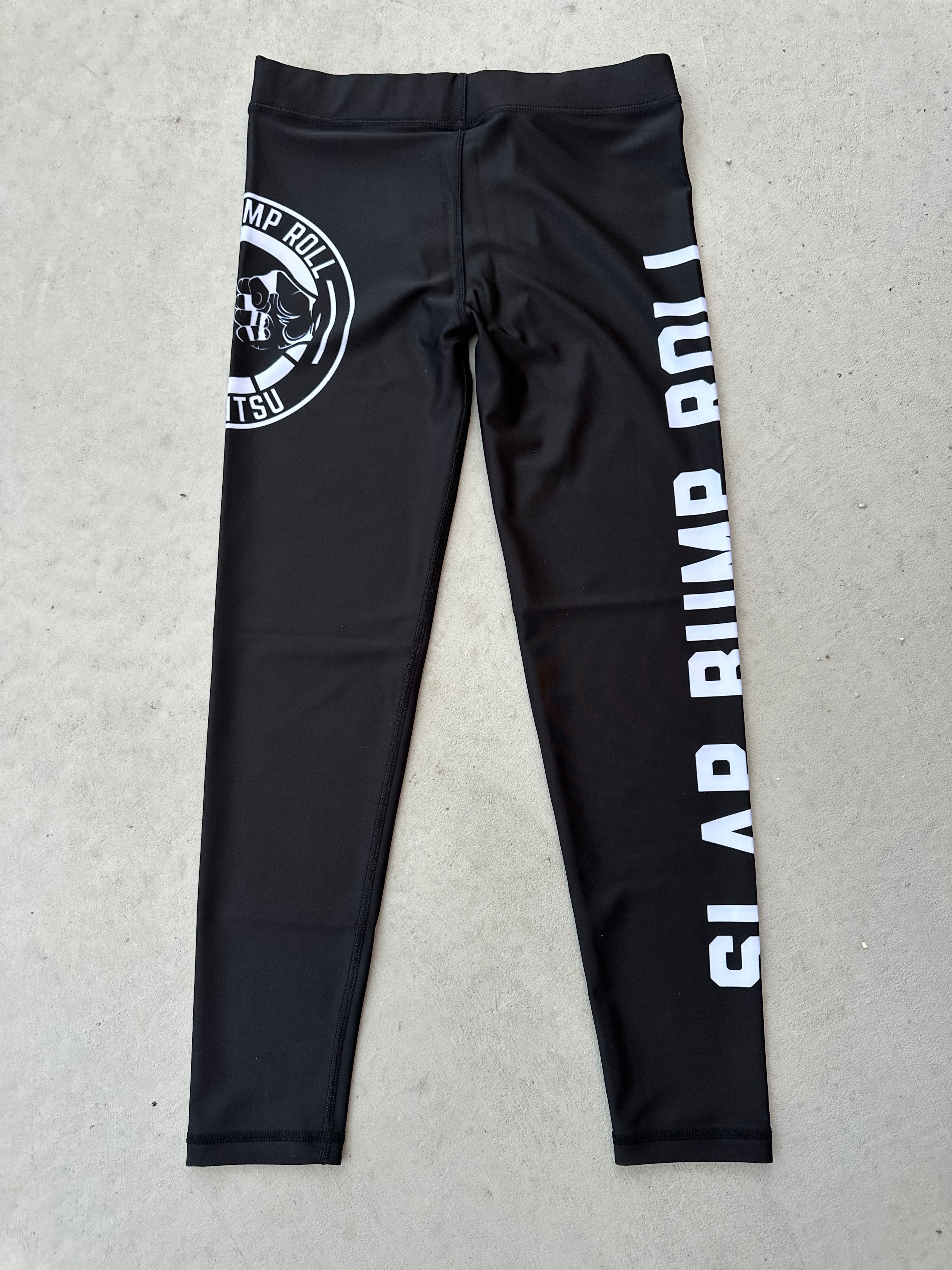 SBR Jiu Jitsu Spats in black with white SLAP BUMP ROLL leg print and fist bump circle logo, no-gi grappling compression tights