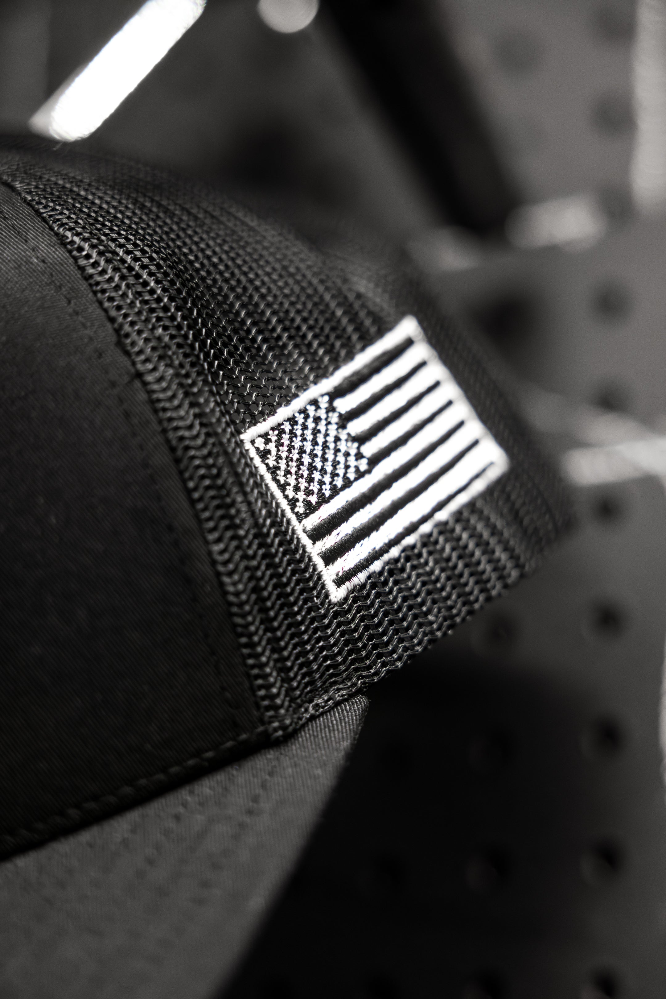Black and white American flag embroidered side patch on SBR Jiu Jitsu Trucker Hat