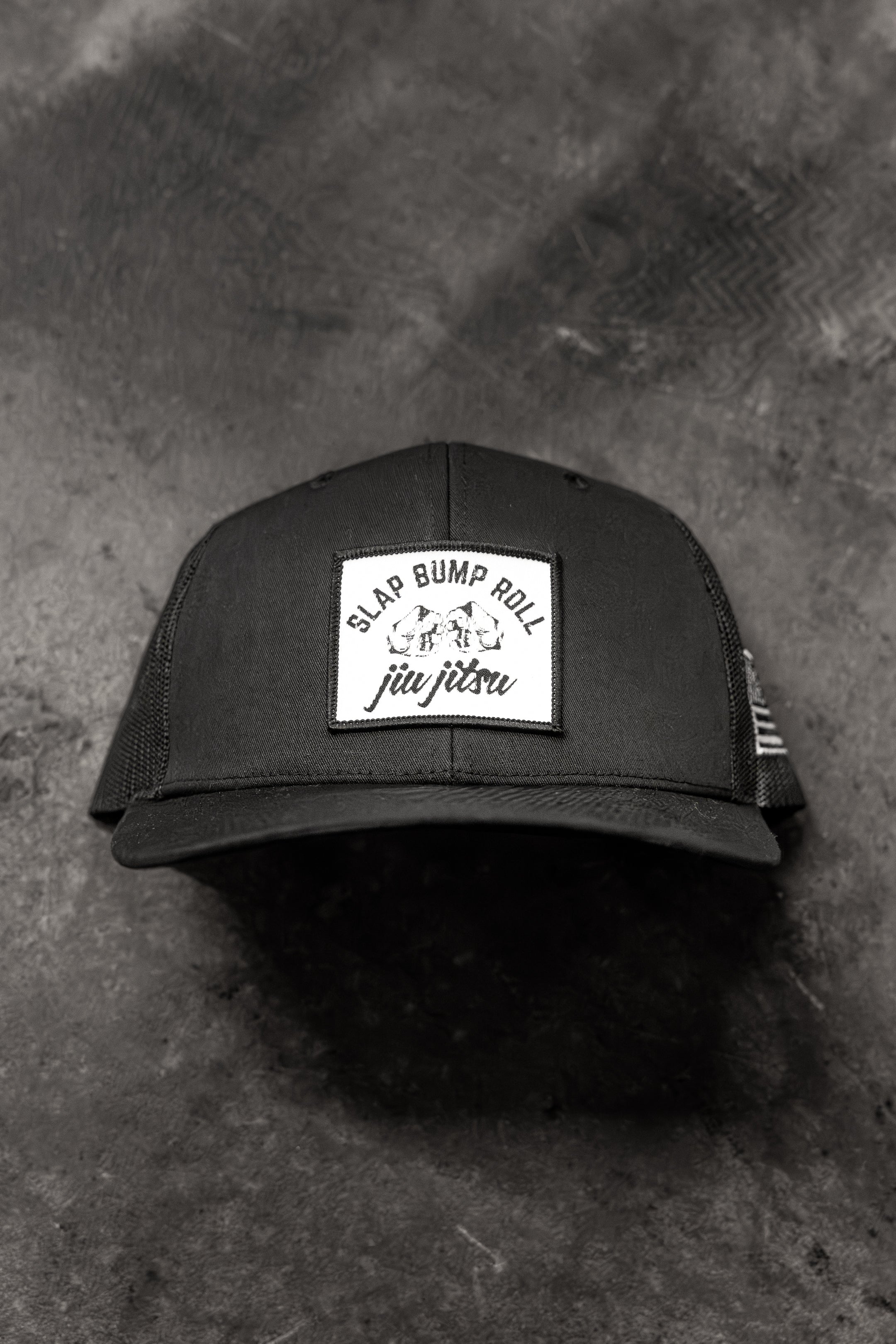 SBR Jiu Jitsu Trucker Hat in black with white Slap Bump Roll patch, mesh-back snapback cap
